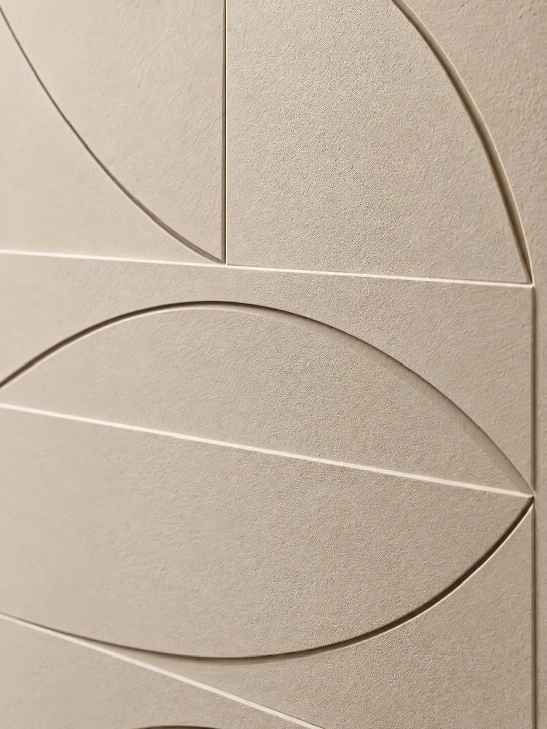 Close-up of the cream relief surface with embossed curved lines