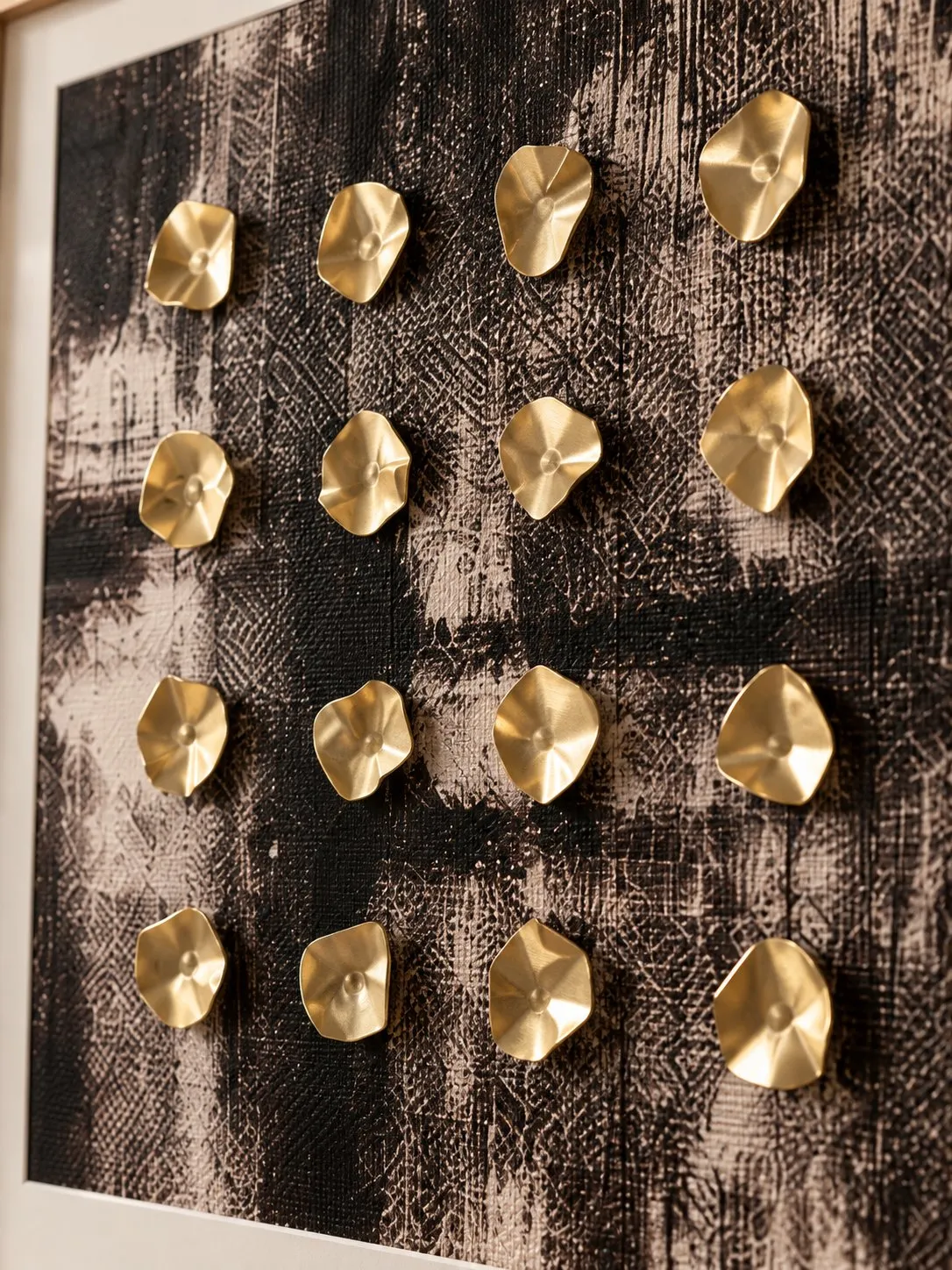 Close-up of the dark textured print with gold faceted discs