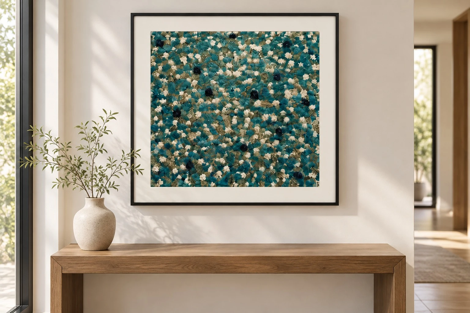 Framed teal cream textured art print above wooden console
