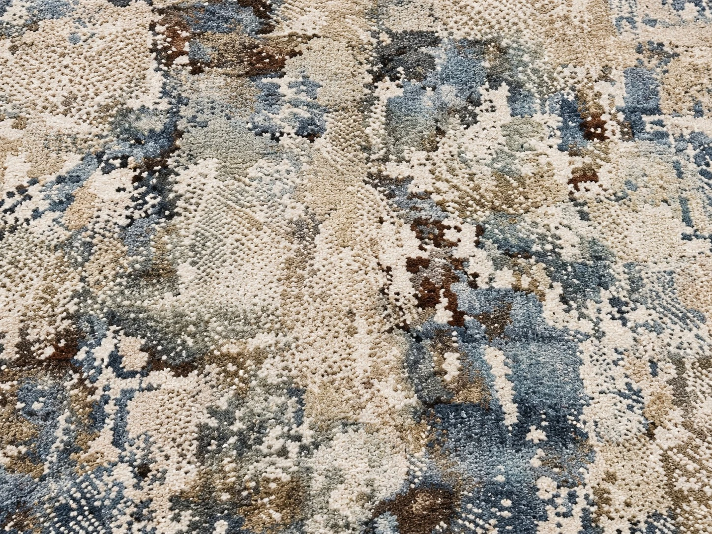 Close-up of the blue, slate, beige and brown mottled texture on the rug
